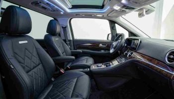 Luxury interior of the Mercedes Viano 2025 featuring premium black leather seats, ambient LED lighting, spacious executive cabin, and modern amenities for chauffeur service in Dubai.